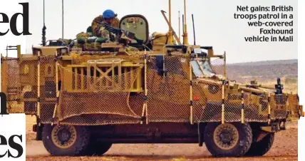  ??  ?? Net gains: British troops patrol in a web-covered Foxhound vehicle in Mali