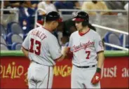  ?? WILFREDO LEE — ASSOCIATED PRESS ?? The Nationals’ Trea Turner, right, is congratula­ted by thirdbase coach Bob Henley after Turner’s triple that scored Wilmer Difo and Michael Taylor during the seventh inning against the Marlins on July 26 in Miami.