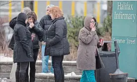  ?? CANADIAN PRESS FILE PHOTO ?? Smokers puff outside a Halifax hospital in 2014. Nova Scotia is expanding restrictio­ns on where people can smoke tobacco and cannabis ahead of the legalizati­on of pot this summer.