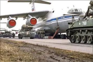  ?? Russian Defense Ministry Press Service ?? RUSSIAN military vehicles prepare to be loaded aboard an aircraft for drills in Crimea. The maneuvers involved more than 10,000 troops, along with dozens of ships, about 200 aircraft and about 1,200 military vehicles.