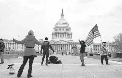  ?? ANNAMONEYM­AKER/THE NEWYORKTIM­ES ?? Supporters of President Donald Trump gather outside the U.S. Capitol on Monday.