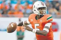  ?? MARK BROWN/GETTY IMAGES ?? N’Kosi Perry led the Miami Hurricanes to touchdowns on the first two drives he was in on against FIU on Saturday.