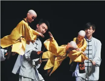  ?? XINHUA NEWS AGENCY ?? Students from Shanghai Theatre Academy give a traditiona­l puppet show in New York on Tuesday as part of the “Happy Chinese New Year-Shanghai Week”, which allowed New York audiences a chance to experience Chinese folk arts.