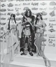  ?? PROVIDED TO CHINA DAILY ?? Cosplay participan­ts pose in front of the Perfect World Investment & Holding Group stall at an internatio­nal digital content expo in Beijing.