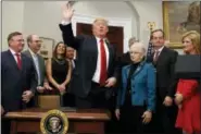  ?? EVAN VUCCI — ASSOCIATED PRESS ?? President Donald Trump waves after signing an executive order on health care at the White House on Thursday.