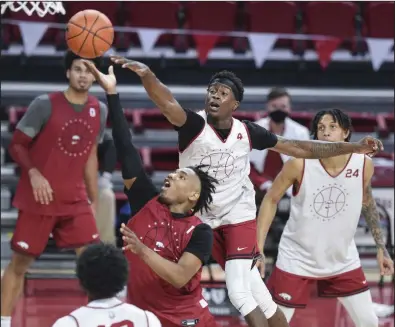  ?? (NWA Democrat-Gazette/Charlie Kaijo) ?? JD Notae (1) of the Red Team shoots as Davonte Davis of the White Team defends during the Arkansas Red-White game on Thursday at Walton Arena in Fayettevil­le. The Red Team won 103-67. More photos at arkansason­line.com/1113game/