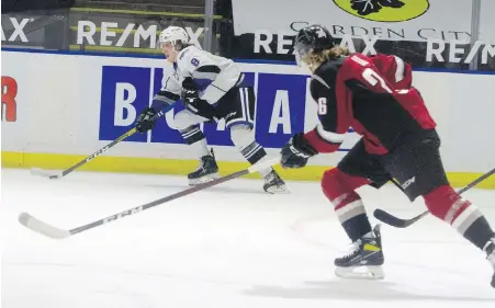  ?? PAIGE BEDNORZ, WESTERN HOCKEY LEAGUE ?? Royals defenceman Kalem Parker looks to pass while being chased down by Giants forward Dallon Wilton during the first period in Kelowna.