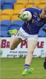  ??  ?? Wicklow’s Oisin McGraynor tries to shake off