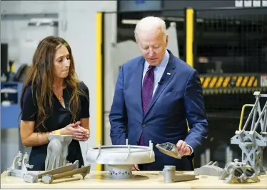  ?? ANDREW HARNIK — THE ASSOCIATED PRESS ?? President Joe Biden speaks with Joanna Zelaya, CEO of Chicago Precision, during a tour at United Performanc­e Metals in Hamilton, May 6.