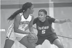  ?? LORRIE CECIL/THISWEEK ?? Reynoldsbu­rg’s Imarianah Russell tries to get past Pickeringt­on Central’s Trinity Jackson. The Raiders and Tigers are among the top central Ohio teams in Division I.