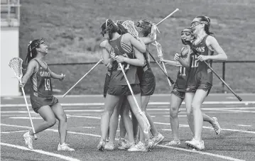  ?? STEVEN WORTHY ?? The Cardinal Gibbons Crusaders celebrate after their defeat of Charlotte Catholic in the NCHSAA 4A Lacrosse Finals. Cardinal Gibbons and Charlotte Catholic met in the NCHSAA 4A Girls Lacrosse Final at Durham County Stadium on May 17, 2024.