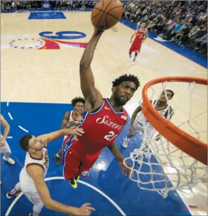  ?? CHRIS SZAGOLA — THE ASSOCIATED PRESS ?? 76ers’ Joel Embiid dunks against Cleveland Cavaliers’ Ante Zizic during the second half of Tuesday’s win.