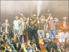  ?? Radis Denphutara­phrechar ?? Super Bowl-winning tight end Travis Kelce sprays the crowd with Champagne as Chiefs teammates cheer him on at XS Nightclub.