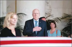  ?? AP/ANDREW HARNIK ?? Sen. Patrick Leahy, D-Vt., (center) pays his respects Monday to Supreme Court Justice John Paul Stevens as he lies in repose in the Great Hall of the Supreme Court in Washington.