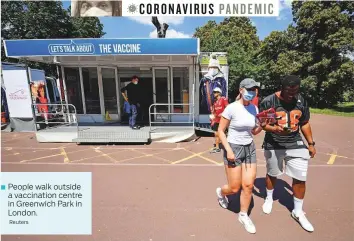  ?? Reuters ?? ■ People walk outside a vaccinatio­n centre in Greenwich Park in London.