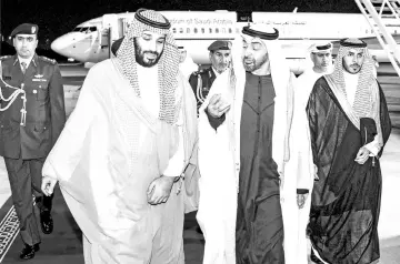  ?? — AFP photo ?? A handout picture shows Mohammed bin Salman (left) being received by Abu Dhabi’s Crown Prince and Deputy Supreme Commander of the UAE Armed Forces, Sheikh Mohamed bin Zayed Al Nahyan, upon the former’s arrival in Abu Dhabi.