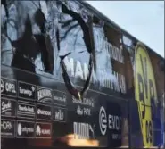  ?? MARTIN MEISSNER — THE ASSOCIATED PRESS ?? A window of Dortmund’s team bus is damaged after an explosion. The team’s match against AS Monaco was reschedule­d for today.