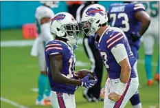  ?? LYNNE SLADKY / AP ?? Bills quarterbac­k Josh Allen (17) congratula­tes wide receiver John Brown (15) after Brown scored a touchdown, during the second half of a game against the Dolphins last week.