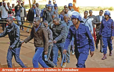  ?? Reuters ?? Some of the 16 people detained after police sealed off the building of the opposition Movement for Democratic Change (MDC Alliance) appear in court in Zimbabwe’s capital Harare on Friday. Zimbabwean President Emmerson Mnangagwa has called for unity in...