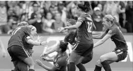  ?? STEPHEN M. DOWELL/ORLANDO SENTINEL ?? Pride players pile onto Danica Evans (second from left) after she scored a goal during a game against the Spirit. The Pride waived Evans Friday so she can pursue opportunit­ies to play in Europe.