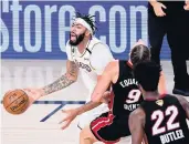 ?? DOUGLAS P. DEFELICE/GETTY IMAGES ?? Los Angeles’ Anthony Davis, left, is called for an offensive foul against Miami’s Kelly Olynyk during Game 3.