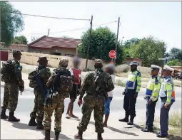  ?? PIC: PHATSIMO KAPENG ?? Police and solders mantaining order during lockdown