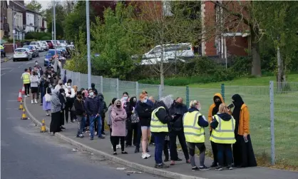  ??  ?? People queuing for Covid vaccinatio­ns at the ESSA academy in Bolton, where the India coronaviru­s variant has been found in high numbers. Photograph: Danny Lawson/PA