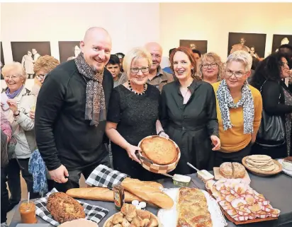  ?? FOTO: ILGNER ?? Marc-Daniel Kress und Anna Link zeigen zusammen mit Annette Coenen-Lösch (Mitte) die verschiede­nen Brotlaibe, die für die Ausstellun­g gebacken wurden.