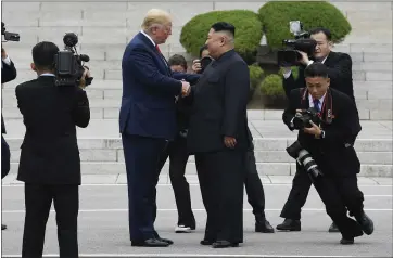  ?? SUSAN WALSH — THE ASSOCIATED PRESS ?? President Donald Trump shakes hands with Kim Jong Un, the North Korean leader, on the North Korean side of the Demilitari­zed Zone at the border village of Panmunjom on Sunday.