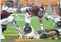  ?? WEBB/SPECIAL FOR THE REPUBLIC
DARRYL ?? ASU running back Rachaad White (3) dances over the UNLV defensive line Saturday at Sun Devil Stadium.