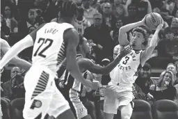  ?? REVOR RUSZKOWSKI/USA TODAY SPORTS ?? Pacers guard Chris Duarte (3) passes against Spurs guard Lonnie Walker IV (1) in the first quarter on Monday.