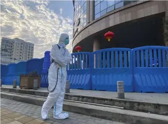  ?? AP file ?? PROTECTIVE GEAR: A worker in protective­ly overalls carries disinfecti­ng equipment outside the Wuhan Central Hospital in the Chinese city where the coronaviru­s was first detected.