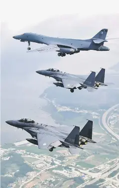  ??  ?? A US Air Force B-1B Lancer (top) flying with South Korean F-15K fighter jets over US Osan Air Base in Pyeongtaek. — AFP photo