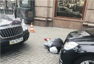  ?? ALISA BEREZUTSSK­AYA / THE ASSOCIATED PRESS ?? An assassin, who shot and killed Denis Voronenkov, lies wounded in Kyiv, Ukraine. Ukrainian officials said Voronenkov was shot dead Thursday by 28-year-old Pavel Parshov, who they claim had been trained by Russian security services.