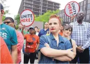  ?? JACQUELINE LARMA/ASSOCIATED PRESS ?? Amanda Hammock, center, is dressed as Rosie the Riveter as she attends a protest by Philadelph­ia Council AFL-CIO in Philadelph­ia on Wednesday.