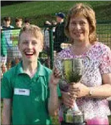  ??  ?? Pictured at the annual Killavulle­n sports day was Deirdre Owens presenting the Gerard Owens Cup to Tomás Fennell, this year’s winner of the perpetual trophy.
