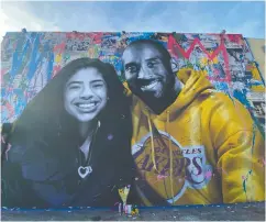  ?? CHRIS DELMAS / AFP VIA GETTY IMAGES FILES ?? A mural by French artist Mr. Brainwash of Kobe Bryant
and his daughter Gigi in Los Angeles.
