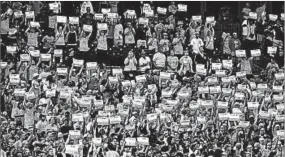  ?? DUANE BURLESON/GETTY ?? Fans at Detroit’s Comerica Park honor breast cancer survivors with signs of their names at a Tigers game last week.