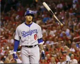 ?? ASSOCIATED PRESS FILE ?? The Dodgers’ Manny Machado flips his bat in the air after striking out during the first inning against the Cardinals in St. Louis last season. Spring training has started, yet two of baseball’s biggest stars, Bryce Harper and Manny Machado, are sitting at home.