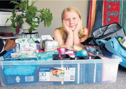  ?? Photo / Stuart Whitaker ?? Twelve-year-old Aliyah with some of the bags and supplies already collected for She is Me.