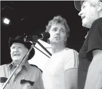  ??  ?? "Dukes of Hazzard" cast members James Best, left, John Schneider, center, and Ben Jones, sing during the DukesFest 2005 in Bristol, Tenn.