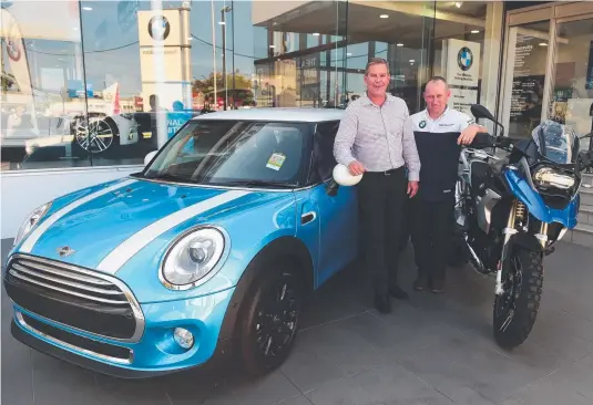  ?? NEW RANGE: Pickerings dealer principal Scott McElligott with Mick Owen with a Mini Cooper and a BMW R1200 GS Rallye X. Picture: EVAN MORGAN ??