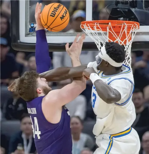  ?? RANDALL BENTON/AP ?? Northweste­rn center Matthew Nicholson (career-high 17 points, nine rebounds) is fouled by UCLA forward Adem Bona in the second half.