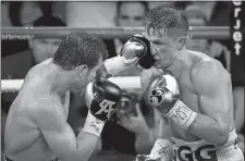  ?? STEVE MARCUS/LAS VEGAS SUN/AP PHOTO ?? Canelo Alvarez, left, lands a punch on Gennady Golovkin during Saturday night’s boxing match at T-Mobile Arena in Las Vegas.