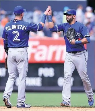  ?? GETTY IMAGES ?? Troy Tulowitzki and Jose Bautista were key factors in the weekend sweep over the Yankees. The win extends the Jays streak to eight games and moves them to within 1 1/ 2 games of the front- running Yankees.