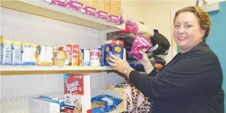  ?? KATHY JOHNSON ?? Shannon Davis, school counsellor at Hillcrest Academy, shows some of the donations that have come into the FREE STORE at the school that will help students and families in need.