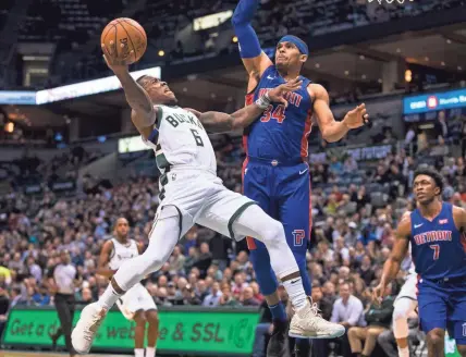  ?? JEFF HANISCH / USA TODAY SPORTS ?? Bucks guard Eric Bledsoe shoots over Pistons forward Tobias Harris on Wednesday night.