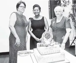  ??  ?? From left: Pat Chuck, president of The Woman Club, Lady Allen and Iris Harvey get ready to cut the anniversar­y cake.