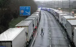  ?? Steve Parsons / Associated Press ?? Trucks are parked near Folkestone, England, after the Port of Dover was closed and access to the Eurotunnel suspended by France over a new COVD-19 strain.