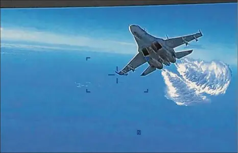  ?? U.S. Department of Defense via Associated Press ?? This photo taken from video released on Thursday shows a Russian Su-27 approachin­g the back of the MQ-9 drone over the Black Sea and beginning to release fuel as it passes, the Pentagon said.